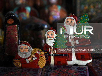 In Srinagar, Kashmir, India, on December 14, 2024, Christmas ornaments of Santa Claus are ready at the workshop before being sent to the mar...