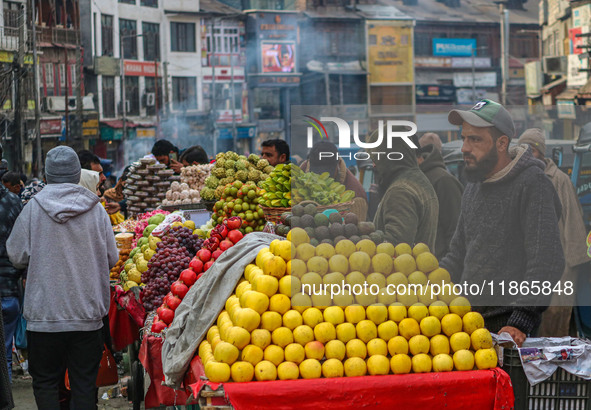 Street vendors sell different kinds of fruits at a market in Srinagar, Jammu and Kashmir, on December 14, 2024. 