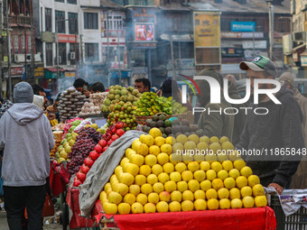 Street vendors sell different kinds of fruits at a market in Srinagar, Jammu and Kashmir, on December 14, 2024. (