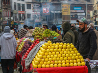 Street vendors sell different kinds of fruits at a market in Srinagar, Jammu and Kashmir, on December 14, 2024. (