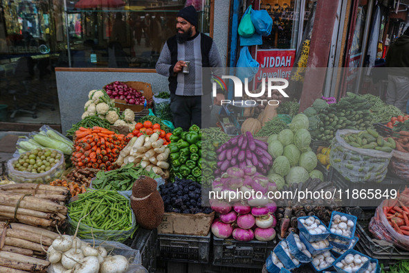 A man sells vegetables at a market in Srinagar, Jammu and Kashmir, on December 14, 2024. 