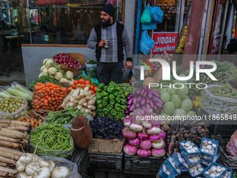 A man sells vegetables at a market in Srinagar, Jammu and Kashmir, on December 14, 2024. (