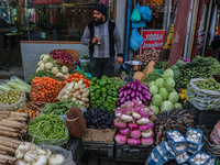 A man sells vegetables at a market in Srinagar, Jammu and Kashmir, on December 14, 2024. (