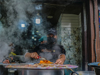 A man prepares Biryani, a traditional mixed rice dish, at a market in Srinagar, Jammu and Kashmir, on December 14, 2024. (