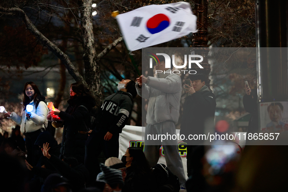 Citizens cheer after the impeachment of President Yoon Suk-yeol is passed in Seoul, South Korea, on December 14, 2024. Approximately 2 milli...