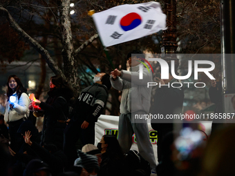 Citizens cheer after the impeachment of President Yoon Suk-yeol is passed in Seoul, South Korea, on December 14, 2024. Approximately 2 milli...