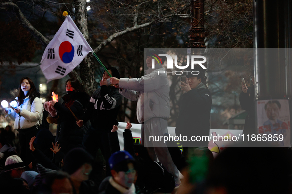 Citizens cheer after the impeachment of President Yoon Suk-yeol is passed in Seoul, South Korea, on December 14, 2024. Approximately 2 milli...