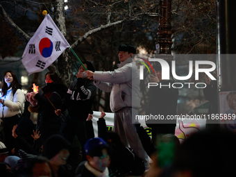 Citizens cheer after the impeachment of President Yoon Suk-yeol is passed in Seoul, South Korea, on December 14, 2024. Approximately 2 milli...