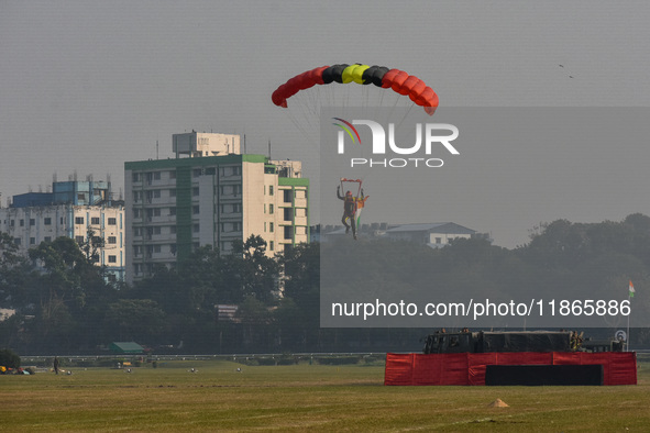 Paratroopers of the Indian Army perform a drop to showcase to the public during the Vijay Diwas celebration, as seen in Kolkata, India, on D...