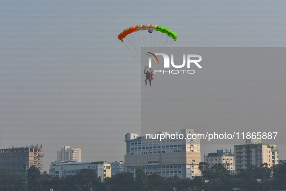 Paratroopers of the Indian Army perform a drop to showcase to the public during the Vijay Diwas celebration, as seen in Kolkata, India, on D...