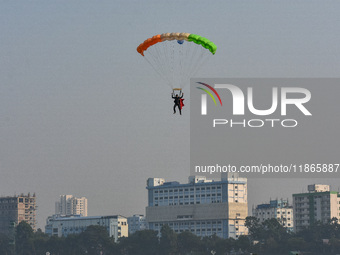 Paratroopers of the Indian Army perform a drop to showcase to the public during the Vijay Diwas celebration, as seen in Kolkata, India, on D...