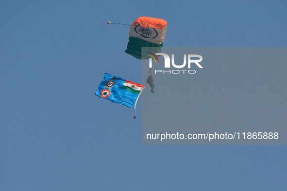 Paratroopers of the Indian Army perform a drop to showcase to the public during the Vijay Diwas celebration, as seen in Kolkata, India, on D...