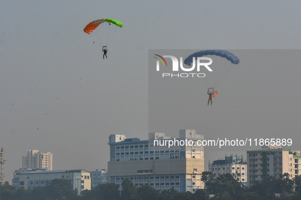 Paratroopers of the Indian Army perform a drop to showcase to the public during the Vijay Diwas celebration, as seen in Kolkata, India, on D...