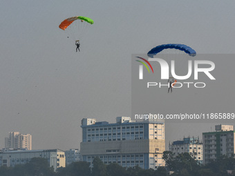 Paratroopers of the Indian Army perform a drop to showcase to the public during the Vijay Diwas celebration, as seen in Kolkata, India, on D...