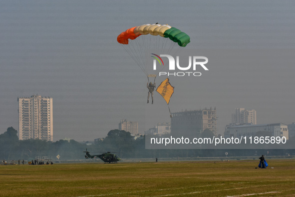 Paratroopers of the Indian Army perform a drop to showcase to the public during the Vijay Diwas celebration, as seen in Kolkata, India, on D...