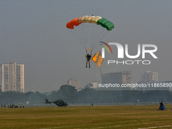 Paratroopers of the Indian Army perform a drop to showcase to the public during the Vijay Diwas celebration, as seen in Kolkata, India, on D...