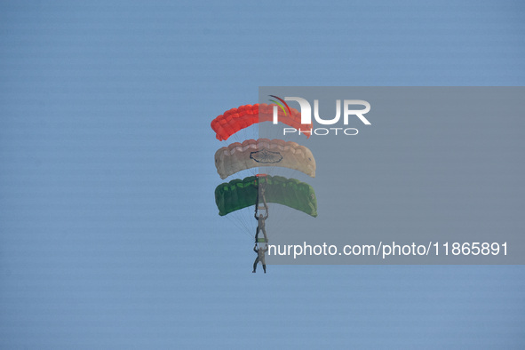 Paratroopers of the Indian Army perform a drop to showcase to the public during the Vijay Diwas celebration, as seen in Kolkata, India, on D...