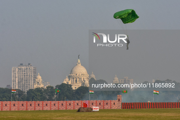 Paratroopers of the Indian Army perform a drop to showcase to the public during the Vijay Diwas celebration, as seen in Kolkata, India, on D...