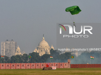 Paratroopers of the Indian Army perform a drop to showcase to the public during the Vijay Diwas celebration, as seen in Kolkata, India, on D...