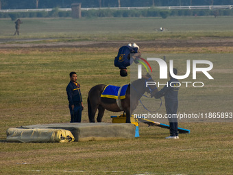 Soldiers of the armed forces perform acrobatic stunts on horses during practice for the Vijay Diwas celebration, as seen in Kolkata, India,...