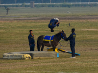 Soldiers of the armed forces perform acrobatic stunts on horses during practice for the Vijay Diwas celebration, as seen in Kolkata, India,...