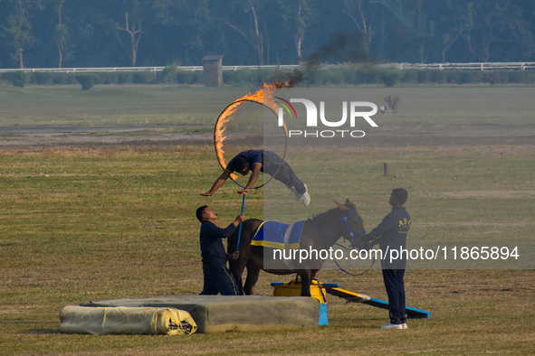 Soldiers of the armed forces perform acrobatic stunts on horses during practice for the Vijay Diwas celebration, as seen in Kolkata, India,...