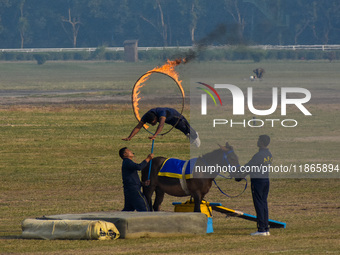 Soldiers of the armed forces perform acrobatic stunts on horses during practice for the Vijay Diwas celebration, as seen in Kolkata, India,...