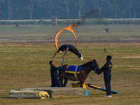 Soldiers of the armed forces perform acrobatic stunts on horses during practice for the Vijay Diwas celebration, as seen in Kolkata, India,...