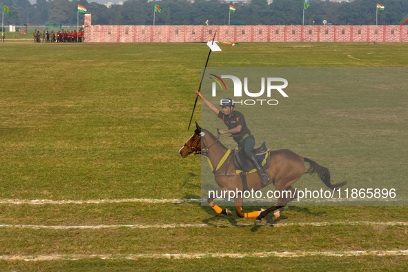 Soldiers of the armed forces perform acrobatic stunts on horses during practice for the Vijay Diwas celebration, as seen in Kolkata, India,...