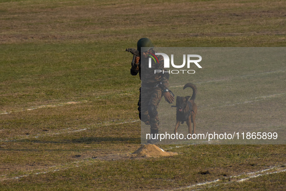 An officer and his army dog display to the public during practice ahead of the Vijay Diwas celebration, as seen in Kolkata, India, on Decemb...