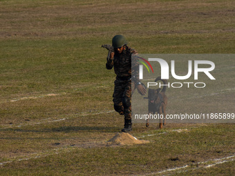 An officer and his army dog display to the public during practice ahead of the Vijay Diwas celebration, as seen in Kolkata, India, on Decemb...