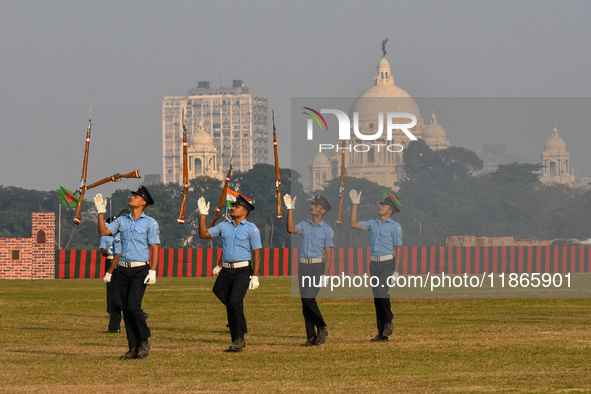 Officers of the Indian Air Force perform stunts with rifles during a practice ahead of the Vijay Diwas celebration in Kolkata, India, on Dec...