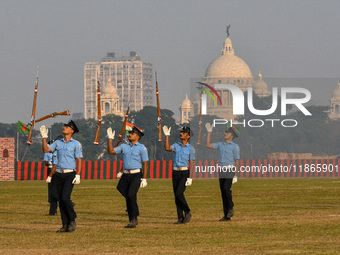 Officers of the Indian Air Force perform stunts with rifles during a practice ahead of the Vijay Diwas celebration in Kolkata, India, on Dec...