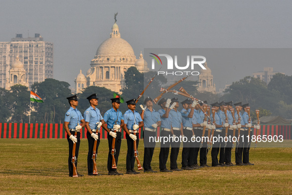 Officers of the Indian Air Force perform stunts with rifles during a practice ahead of the Vijay Diwas celebration in Kolkata, India, on Dec...