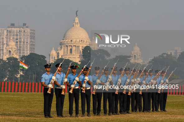 Officers of the Indian Air Force perform stunts with rifles during a practice ahead of the Vijay Diwas celebration in Kolkata, India, on Dec...