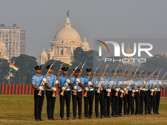 Officers of the Indian Air Force perform stunts with rifles during a practice ahead of the Vijay Diwas celebration in Kolkata, India, on Dec...