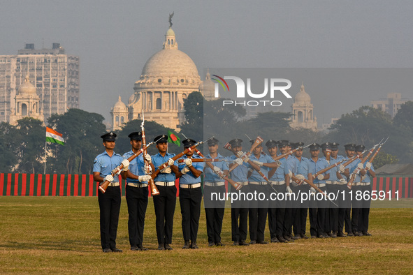 Officers of the Indian Air Force perform stunts with rifles during a practice ahead of the Vijay Diwas celebration in Kolkata, India, on Dec...