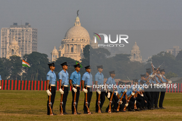 Officers of the Indian Air Force perform stunts with rifles during a practice ahead of the Vijay Diwas celebration in Kolkata, India, on Dec...