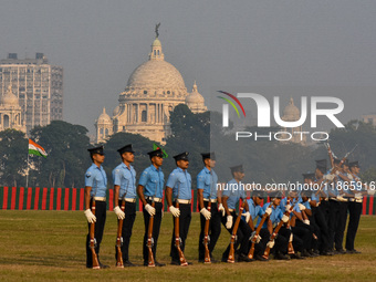 Officers of the Indian Air Force perform stunts with rifles during a practice ahead of the Vijay Diwas celebration in Kolkata, India, on Dec...