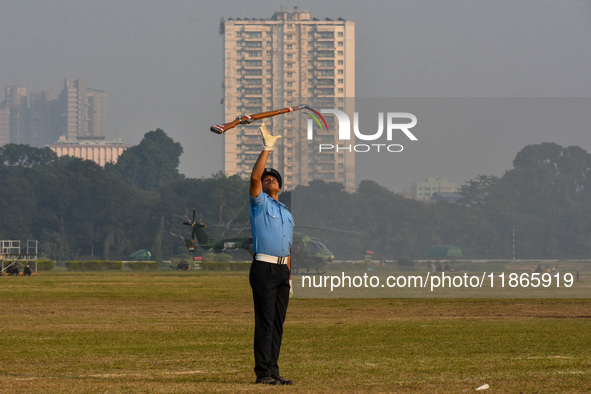 Officers of the Indian Air Force perform stunts with rifles during a practice ahead of the Vijay Diwas celebration in Kolkata, India, on Dec...