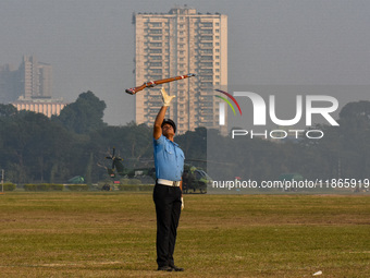 Officers of the Indian Air Force perform stunts with rifles during a practice ahead of the Vijay Diwas celebration in Kolkata, India, on Dec...