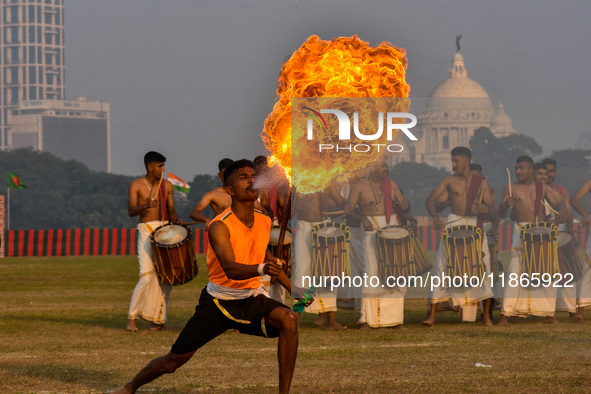 Soldiers perform stunts with fire during a practice display ahead of the Vijay Diwas celebration in Kolkata, India, on December 14, 2024. 'V...