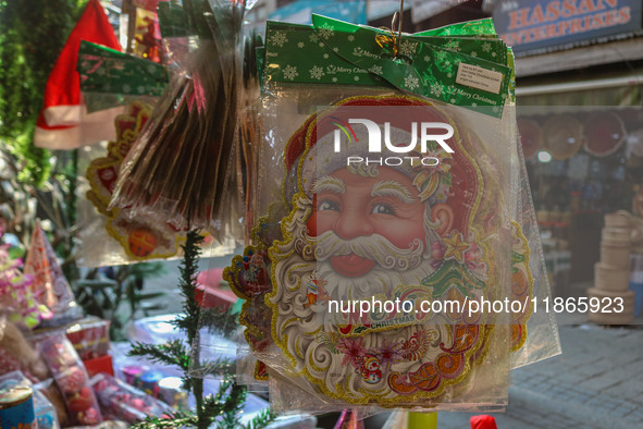 Santa Claus items are seen in a shop at a market ahead of the Christmas celebrations in Srinagar, Jammu and Kashmir, on December 14, 2024. 