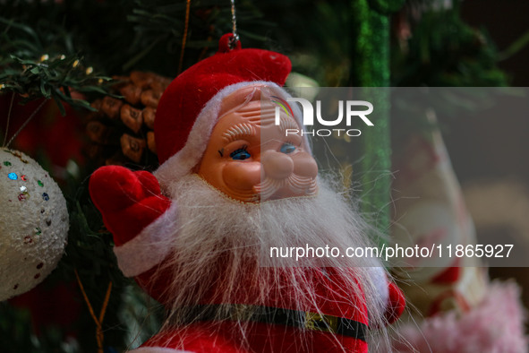 A Santa Claus decorative article is displayed at a market ahead of the Christmas celebrations in Srinagar, Jammu and Kashmir, on December 14...