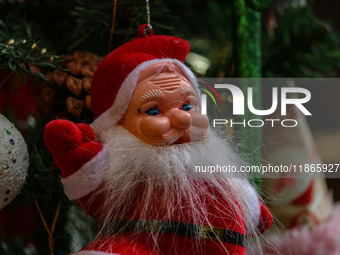 A Santa Claus decorative article is displayed at a market ahead of the Christmas celebrations in Srinagar, Jammu and Kashmir, on December 14...