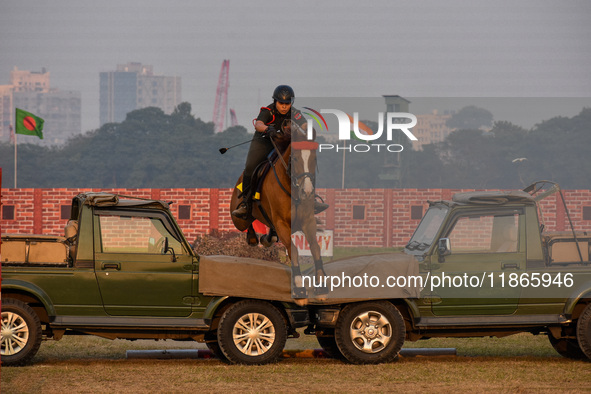 Soldiers of the armed forces perform acrobatic stunts on horses during practice for the Vijay Diwas celebration, as seen in Kolkata, India,...