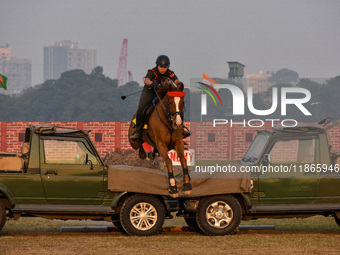 Soldiers of the armed forces perform acrobatic stunts on horses during practice for the Vijay Diwas celebration, as seen in Kolkata, India,...