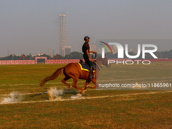 Soldiers of the armed forces perform acrobatic stunts on horses during practice for the Vijay Diwas celebration, as seen in Kolkata, India,...