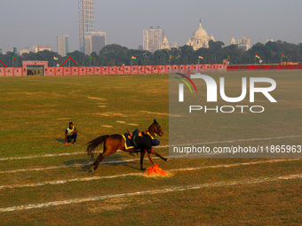 Soldiers of the armed forces perform acrobatic stunts on horses during practice for the Vijay Diwas celebration, as seen in Kolkata, India,...