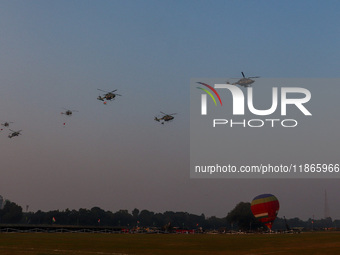 Indian army helicopters display maneuvers during a practice ahead of the Vijay Diwas celebration in Kolkata, India, on December 14, 2024. (